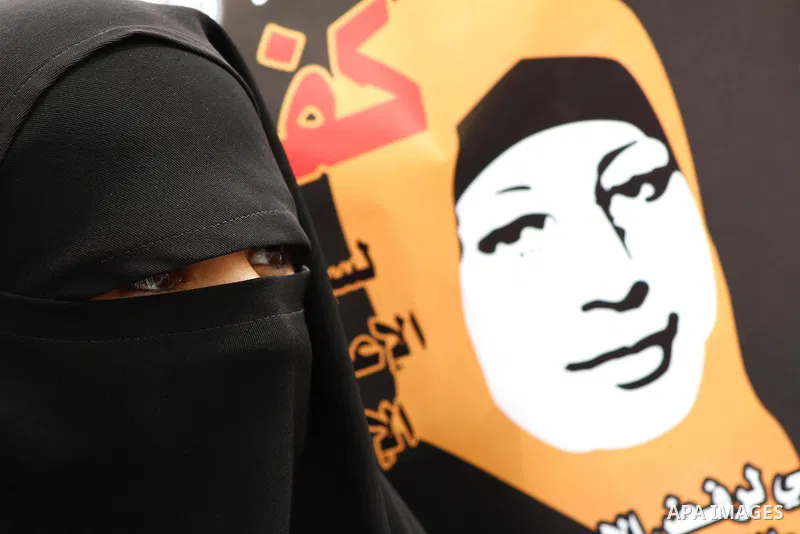 A Palestinian Hamas muslim women next to a poster of Hana Shalaby during a rally at the Palestinian Parliament in Gaza City on, 25 March 2012. Reports state that Hanna Shalabe a Palestinian prisoner in an Israel prison h...