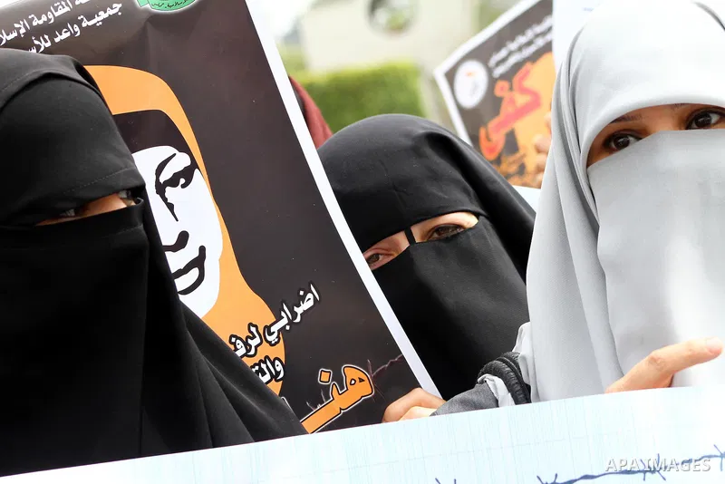 A Palestinian Hamas muslim women next to a poster of Hana Shalaby during a rally at the Palestinian Parliament in Gaza City on, 25 March 2012. Reports state that Hanna Shalabe a Palestinian prisoner in an Israel prison h...