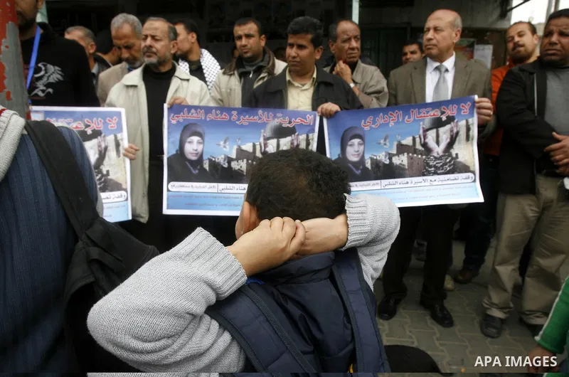 Palestinians hold portraits of jailed compatriot Hana Shalabi, in Rafah on the southern Gaza Strip on, 25 March 2012. Reports state that Hana Shalaby a Palestinian prisoner in an Israel prison has been on a hunger strike...