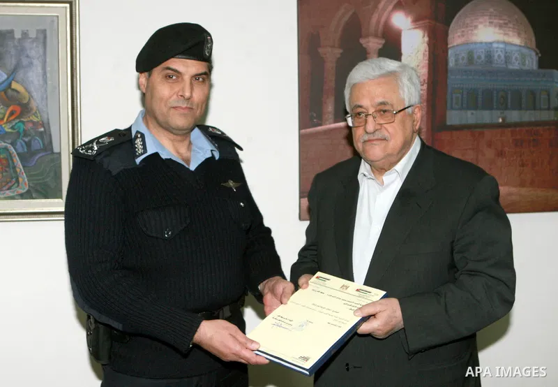 Palestinian President, Mahmoud Abbas (Abu Mazen) receives the annual report of the achievements of the Palestinian police, in the West Bank city of Ramallah on Mar. 25, 2012. Photo by Thaer Ganaim