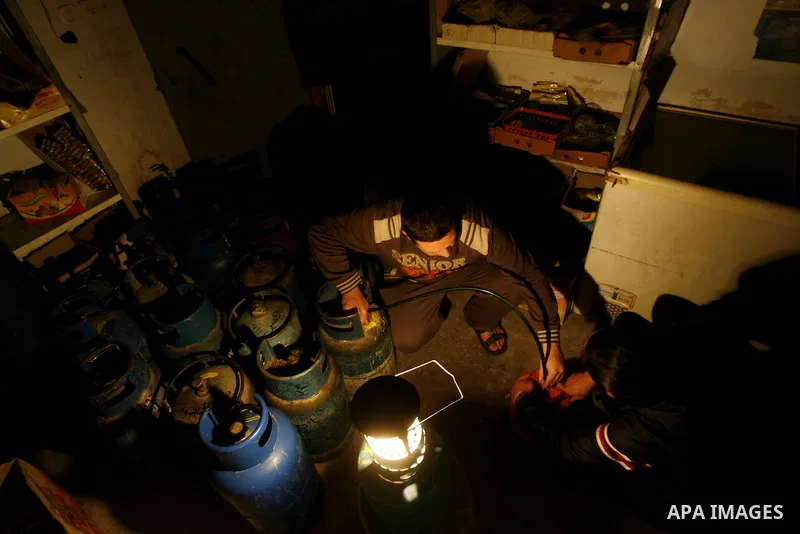 A Palestinian man fills gas cylinders in Rafah on the southern Gaza Strip on, 26 March 2012. Palestinians in the Gaza Strip are suffering a crisis of dry petrol pumps and frequent blackouts triggered by a fuel supply dis...