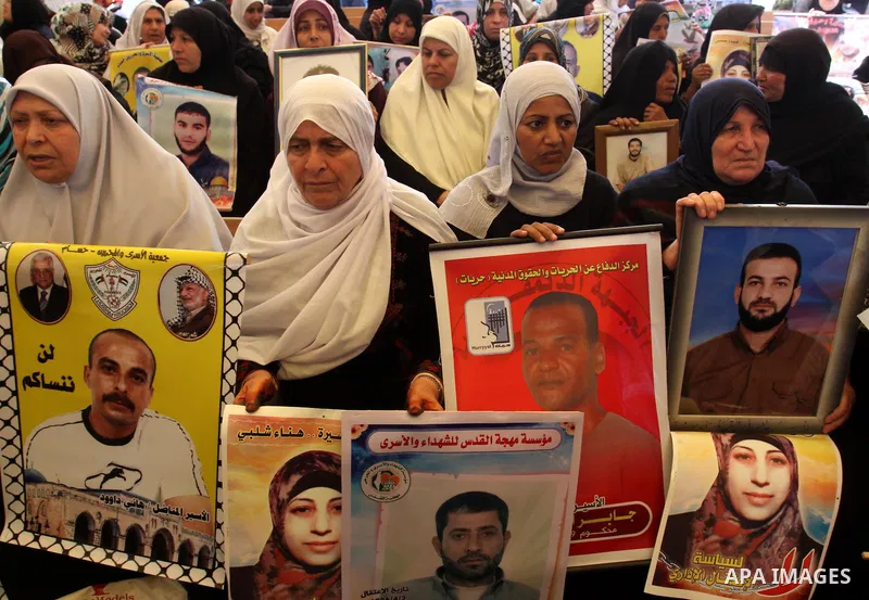Palestinians gather during a protest at the Red Cross' offices in Gaza City to call for the release of Palestinian prisoners held in Israeli jails, on March 26, 2012. Photo by Mohammed Asad