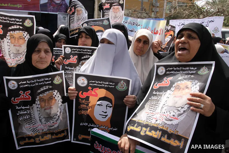 Palestinian women hold portrait of jailed compatriot Hana Shalabi, a female Palestinian prisoner jailed in Israel, outside the Red Cross building in Gaza City on March 26, 2012. Photo by Mohammed Asad
