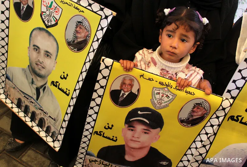 Palestinians gather during a protest at the Red Cross' offices in Gaza City to call for the release of Palestinian prisoners held in Israeli jails, on March 26, 2012. Photo by Mohammed Asad