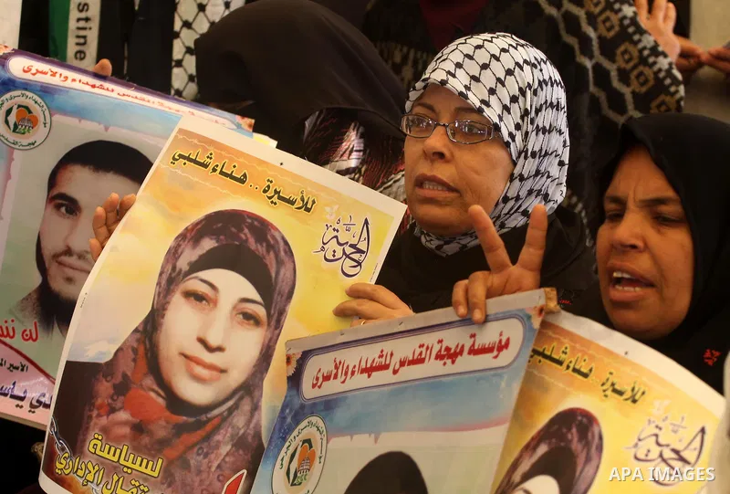 Palestinian women hold portrait of jailed compatriot Hana Shalabi, a female Palestinian prisoner jailed in Israel, outside the Red Cross building in Gaza City on March 26, 2012. Photo by Mohammed Asad