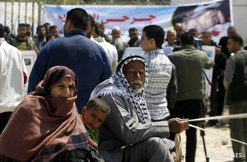 Palestinian demonstrators hold posters during a protest in the Rafah border crossing with Egypt on March 26, 2012, demanding Egypt provide the Gaza Strip with electricity and fuel. The Palestinian energy authority in Gaz...