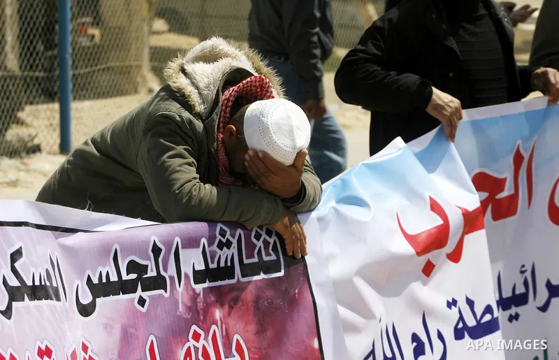 Palestinian demonstrators hold posters during a protest in the Rafah border crossing with Egypt on March 26, 2012, demanding Egypt provide the Gaza Strip with electricity and fuel. The Palestinian energy authority in Gaz...