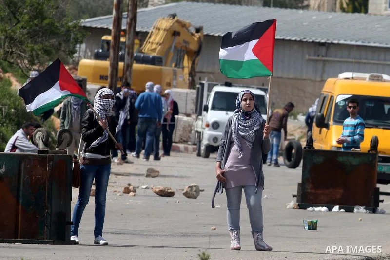 Palestinians clash with Israeli troops, not seen, during a protest outside the Ofer military prison, near the West Bank city of Ramallah Monday, March 26, 2012. Clashes erupted during a demonstration calling to release p...