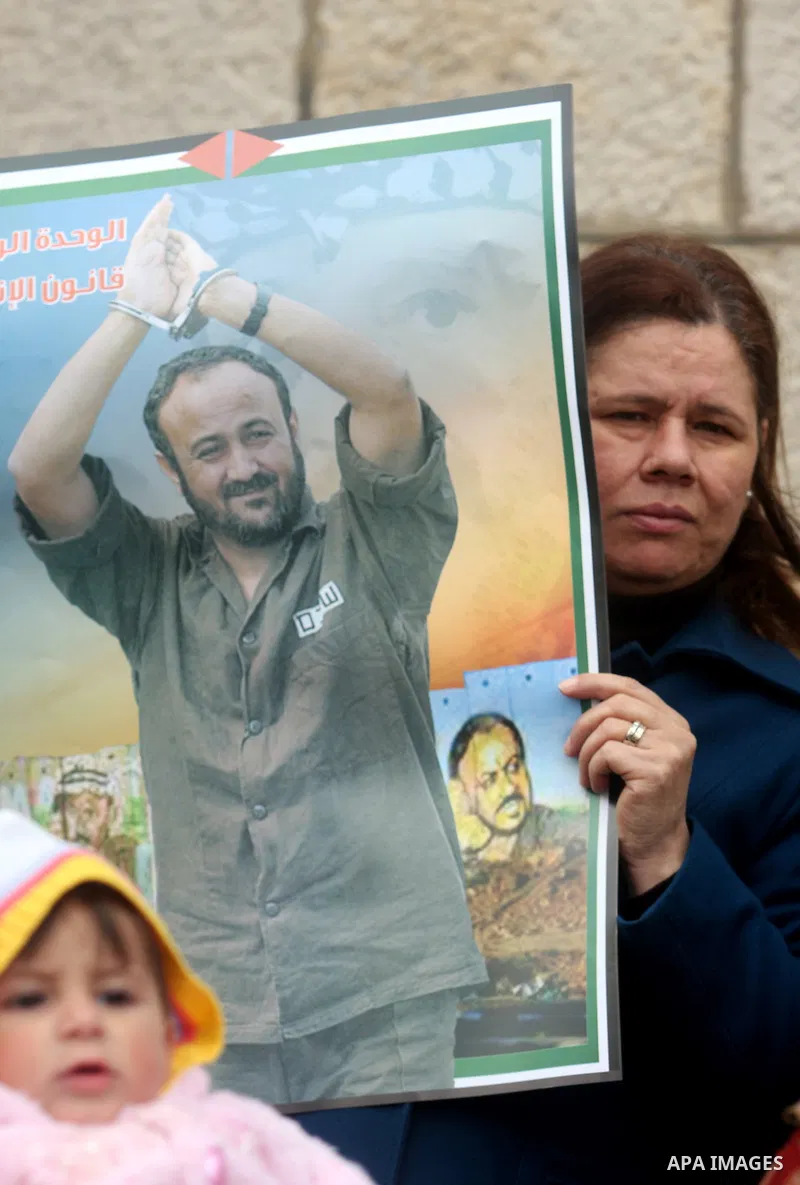 Palestinians hold portraits of Islamic Jihad supporter Hana Shalabi, a female Palestinian prisoner jailed in Israel who has been on hunger strike for 35 days, during a rally in solidarity with Palestinian prisoners in Is...