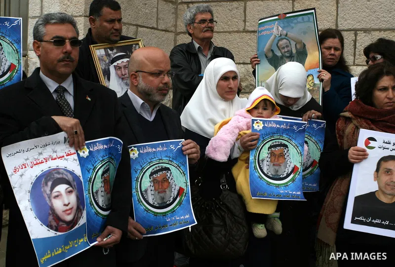 Palestinians hold portraits of Islamic Jihad supporter Hana Shalabi, a female Palestinian prisoner jailed in Israel who has been on hunger strike for 35 days, during a rally in solidarity with Palestinian prisoners in Is...