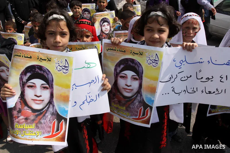 Palestinian children hold portrait of jailed compatriot Hana Shalabi, a female Palestinian prisoner jailed in Israel, outside the Red Cross building in Gaza City on March 27, 2012. Photo by Mohammed Asad