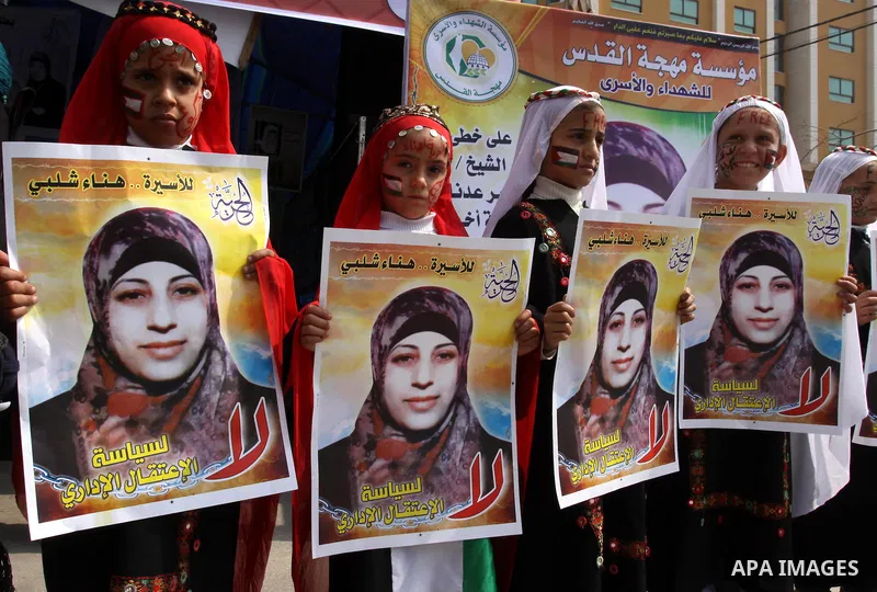 Palestinian children hold portrait of jailed compatriot Hana Shalabi, a female Palestinian prisoner jailed in Israel, outside the Red Cross building in Gaza City on March 27, 2012. Photo by Mohammed Asad