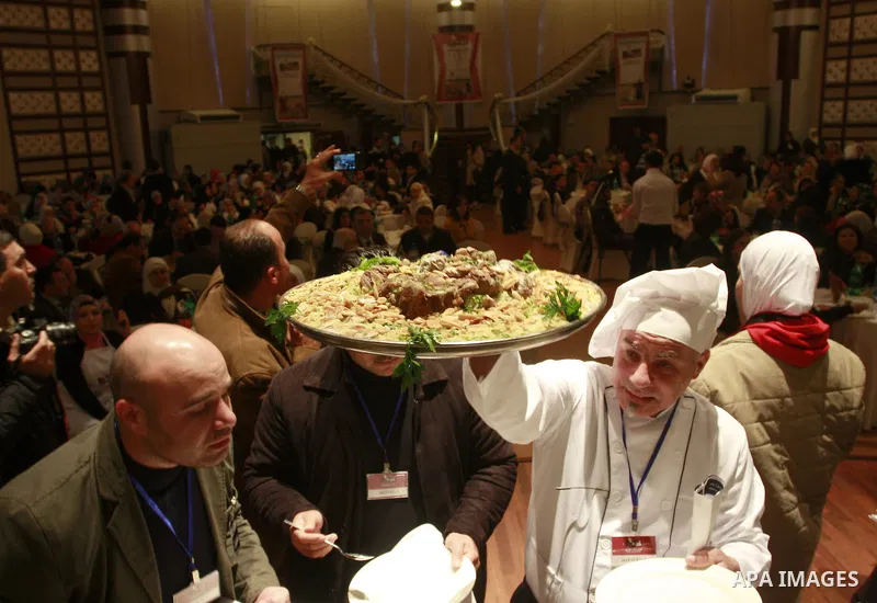 Palestinians take part during festival for the best cook in West Bank city of Nablus Tuesday, March 27, 2012. Photo by Wagdi Eshtayah