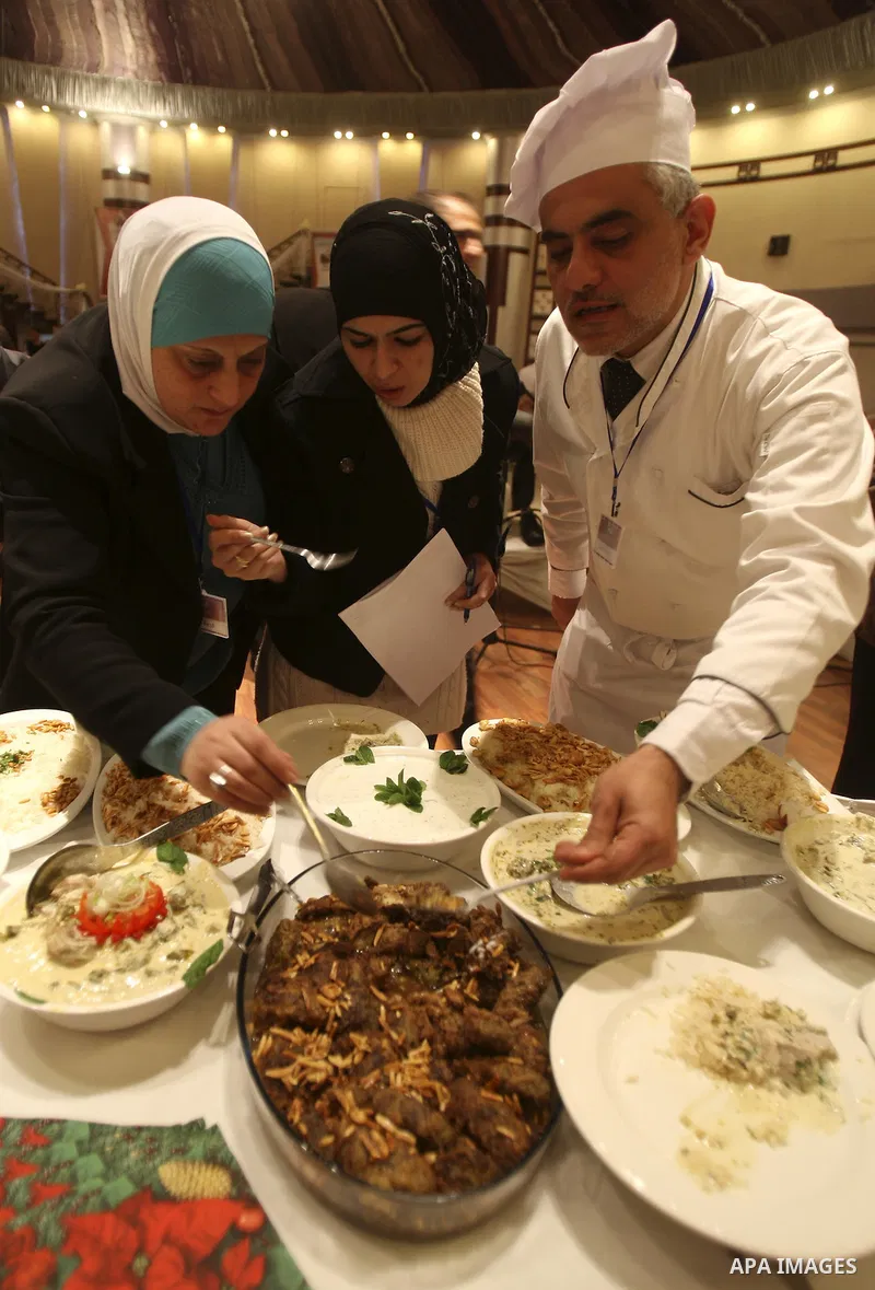 Palestinians take part during festival for the best cook in West Bank city of Nablus Tuesday, March 27, 2012. Photo by Wagdi Eshtayah