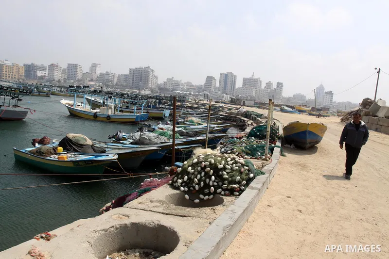 A Palestinian fisherman sits in the port of Gaza city on March 28, 2012, after his boat stopped working due to lack of fuel. Gaza is experiencing a major electricity crisis because of a shortage of fuel for the power pla...