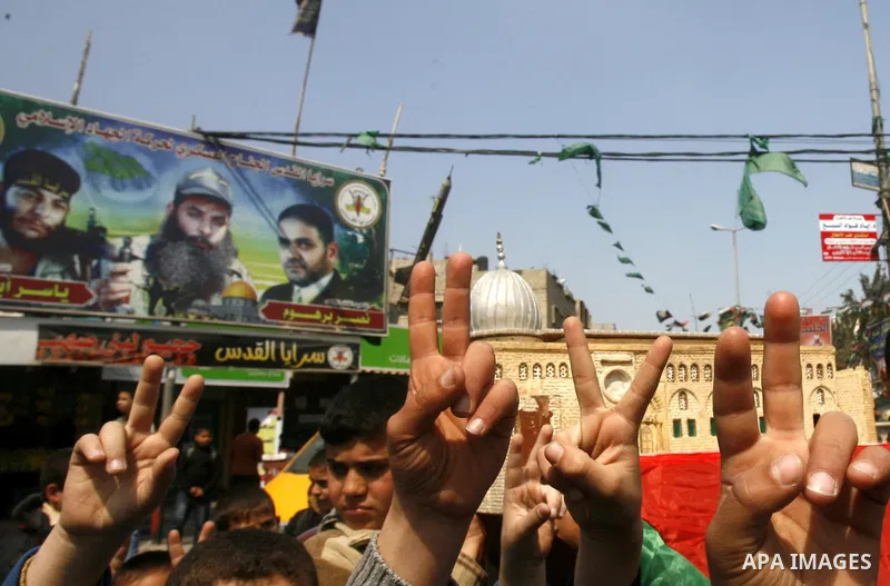 Palestinian children hold logos during protest in Rafah on the southern Gaza Strip on, 28 March 2012 . Gaza is experiencing a major electricity crisis because of a shortage of fuel for the power plant. Photo by Eyad Al B...