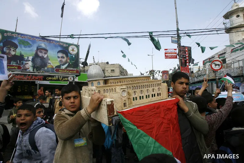 Palestinian children hold logos during protest in Rafah on the southern Gaza Strip on, 28 March 2012 . Gaza is experiencing a major electricity crisis because of a shortage of fuel for the power plant. Photo by Eyad Al B...