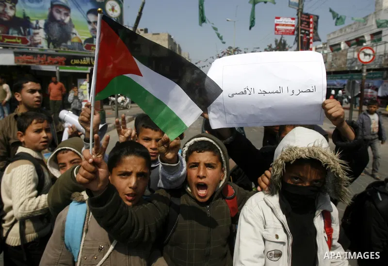 Palestinian children hold logos during protest in Rafah on the southern Gaza Strip on, 28 March 2012 . Gaza is experiencing a major electricity crisis because of a shortage of fuel for the power plant. Photo by Eyad Al B...