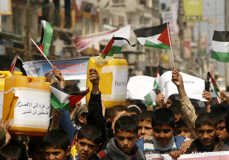 Palestinian children hold logos during protest in Rafah on the southern Gaza Strip on, 28 March 2012 . Gaza is experiencing a major electricity crisis because of a shortage of fuel for the power plant. Photo by Eyad Al B...
