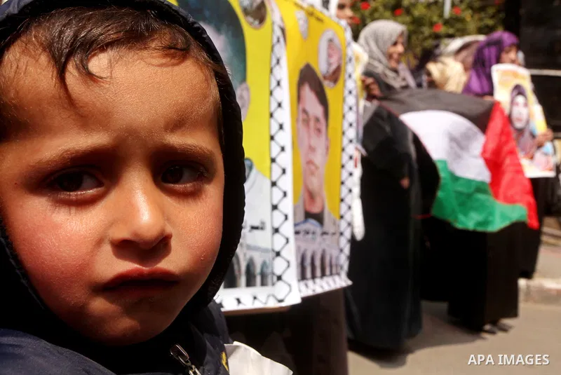 A Palestinian boy attends a rally in Gaza City, calling for the release of Palestinian prisoners from Israeli jails March 28, 2012. Photo by Ashraf Amra