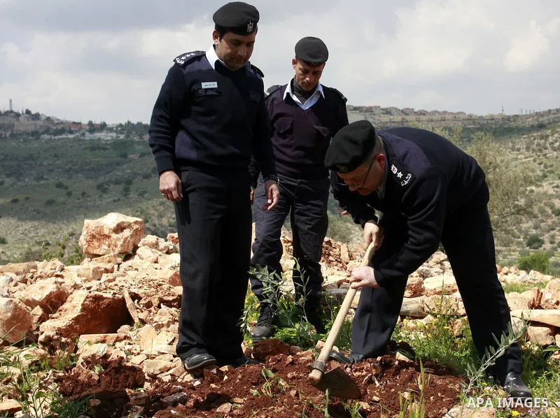Palestinian security officers plant trees during an event marking Land Day ,in the village of Kufr Diek , West Bank, Thursday , March 29, 2011. Land Day commemorates the killing of six Arab citizens of Israel by the Isra...