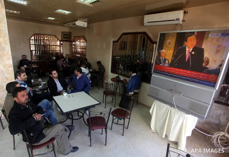 Palestinians watch TV. during a meeting of Arab foreign ministers in the framework of the Arab summit in Baghdad, Iraq, March 29, 2012. Photo by Ashraf Amra