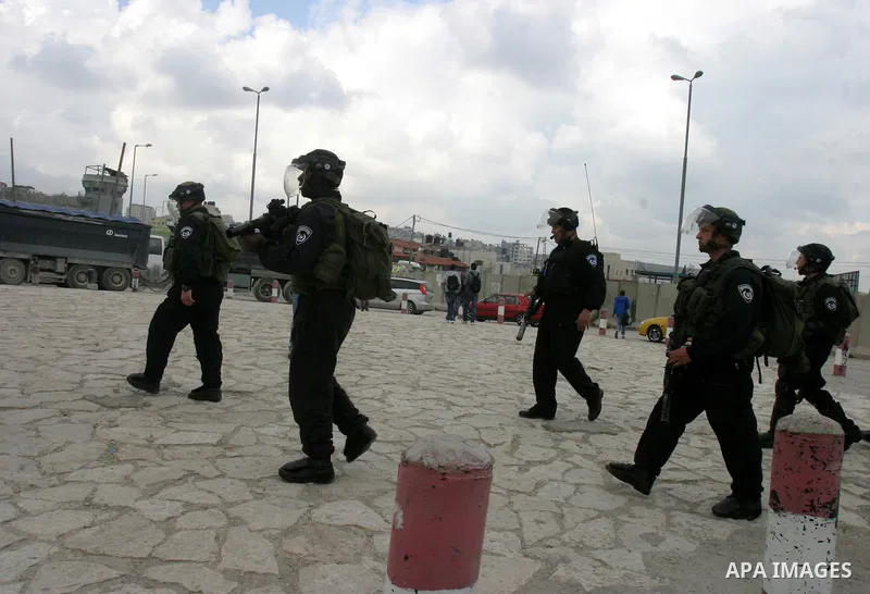 Israeli soldiers take position during clashes with Palestinian youths at the Qalandia checkpoint between the West Bank city of Ramallah and Jerusalem, on 29 March 2012. Photo by Mahfouz Abu Turk