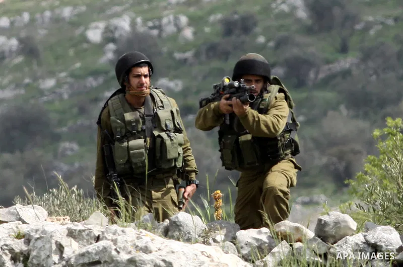Israeli soldiers fire tear gas canisters towards Palestinian protesters during a demonstration to mark the anniversary of Land Day in the village Iraq Burin, near town of Nablus in the occupied Israeli West bank on March...