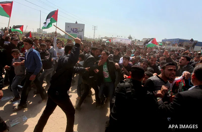 Members of Hamas security forces prevent Palestinian protesters from reaching the border between Israel and the northern Gaza Strip, after a protest marking Land Day March 30, 2012. Israeli security forces fired rubber b...