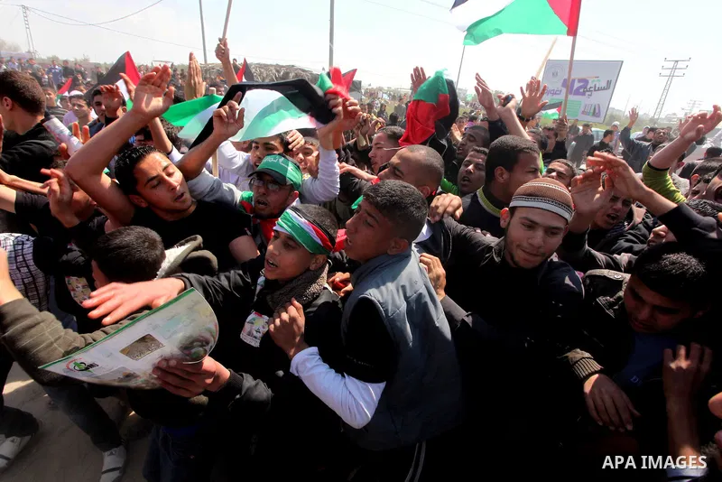 Members of Hamas security forces prevent Palestinian protesters from reaching the border between Israel and the northern Gaza Strip, after a protest marking Land Day March 30, 2012. Israeli security forces fired rubber b...