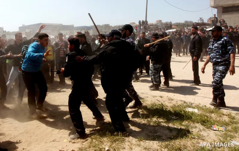 Members of Hamas security forces prevent Palestinian protesters from reaching the border between Israel and the northern Gaza Strip, after a protest marking Land Day March 30, 2012. Israeli security forces fired rubber b...