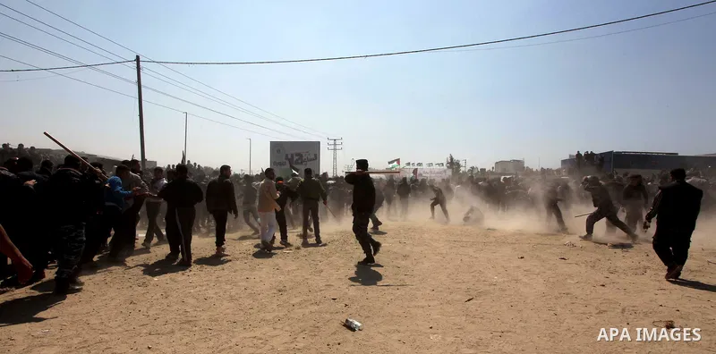Members of Hamas security forces prevent Palestinian protesters from reaching the border between Israel and the northern Gaza Strip, after a protest marking Land Day March 30, 2012. Israeli security forces fired rubber b...