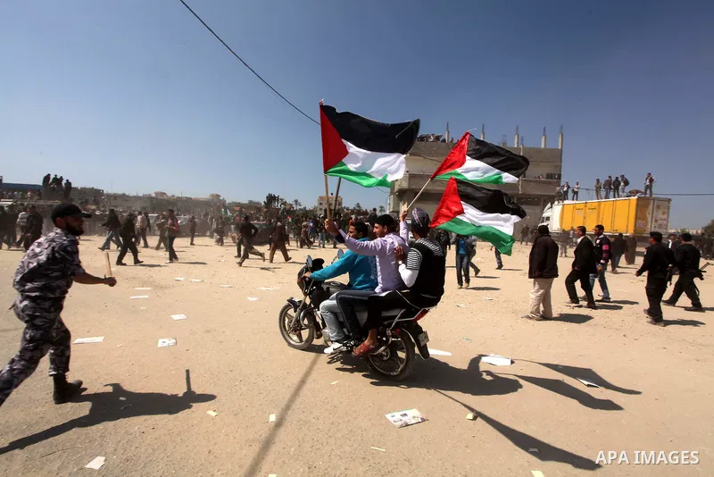 Members of Hamas security forces prevent Palestinian protesters from reaching the border between Israel and the northern Gaza Strip, after a protest marking Land Day March 30, 2012. Israeli security forces fired rubber b...