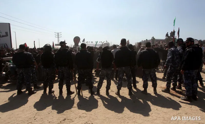 Members of Hamas security forces prevent Palestinian protesters from reaching the border between Israel and the northern Gaza Strip, after a protest marking Land Day March 30, 2012. Israeli security forces fired rubber b...