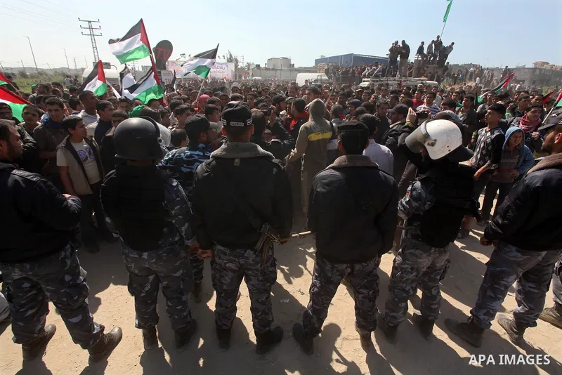 Members of Hamas security forces prevent Palestinian protesters from reaching the border between Israel and the northern Gaza Strip, after a protest marking Land Day March 30, 2012. Israeli security forces fired rubber b...
