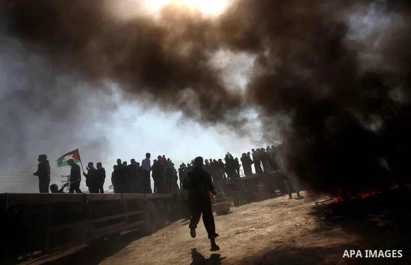 Palestinian protesters shout during a protest marking Land Day, near the border between Israel and the northern Gaza Strip March 30, 2012. Israeli security forces fired rubber bullets, tear gas and stun grenades to break...