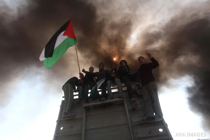Palestinian protesters shout during a protest marking Land Day, near the border between Israel and the northern Gaza Strip March 30, 2012. Israeli security forces fired rubber bullets, tear gas and stun grenades to break...