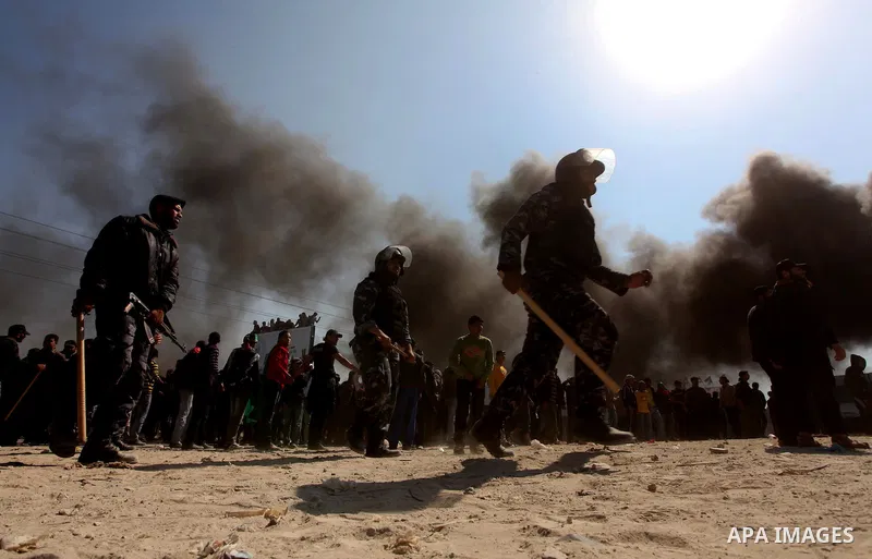 Members of Hamas security forces prevent Palestinian protesters from reaching the border between Israel and the northern Gaza Strip, after a protest marking Land Day March 30, 2012. Israeli security forces fired rubber b...