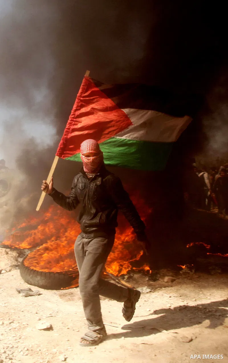 Palestinian protesters shout during a protest marking Land Day, near the border between Israel and the northern Gaza Strip March 30, 2012. Israeli security forces fired rubber bullets, tear gas and stun grenades to break...