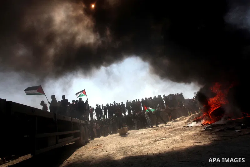 Palestinian protesters shout during a protest marking Land Day, near the border between Israel and the northern Gaza Strip March 30, 2012. Israeli security forces fired rubber bullets, tear gas and stun grenades to break...