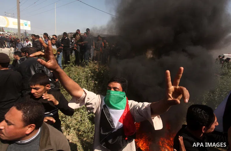 Palestinian protesters shout during a protest marking Land Day, near the border between Israel and the northern Gaza Strip March 30, 2012. Israeli security forces fired rubber bullets, tear gas and stun grenades to break...