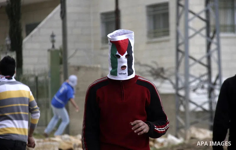 Palestinian protesters throw stones at Israeli soldiers during a demonstration to mark the anniversary of Land Day in the village Kafr Qaddum, close to the northern town of Nablus in the occupied Israeli West bank on Mar...