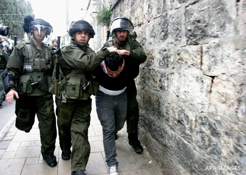 Israeli border police officers detain a Palestinian protester during clashes on Land Day after Friday prayers outside Damascus Gate in Jerusalem's Old City March 30, 2012. Israeli security forces fired rubber bullets, te...