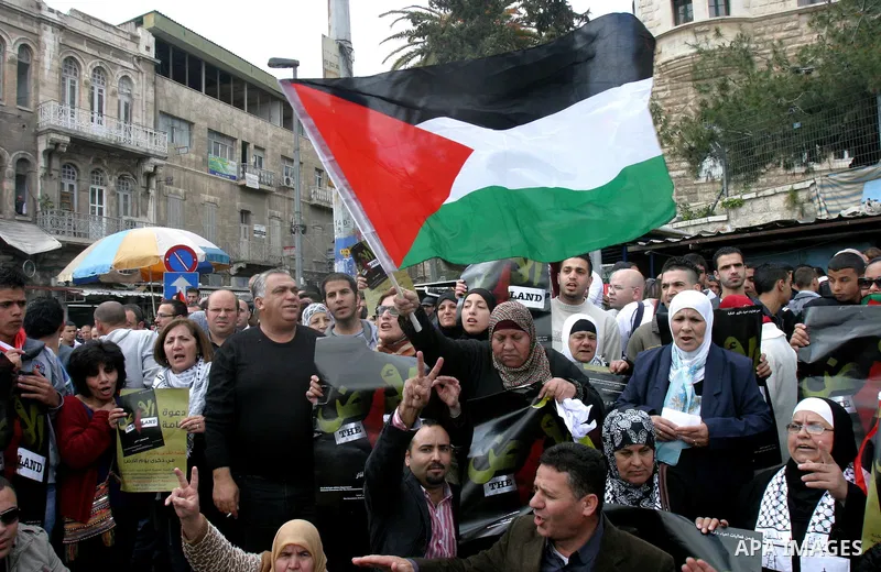 Palestinian protesters take part in a demonstration on Land Day outside Damascus Gate in Jerusalem's Old City March 30, 2012. Israeli security forces fired rubber bullets, tear gas and stun grenades to break up groups of...