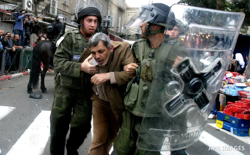 Israeli border police officers detain a Palestinian protester during clashes on Land Day after Friday prayers outside Damascus Gate in Jerusalem's Old City March 30, 2012. Israeli security forces fired rubber bullets, te...