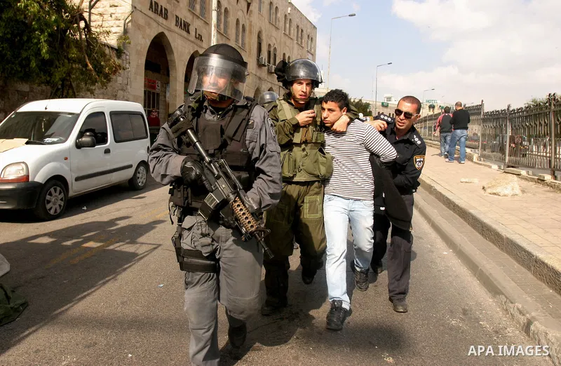 Israeli border police officers detain a Palestinian protester during clashes on Land Day after Friday prayers outside Damascus Gate in Jerusalem's Old City March 30, 2012. Israeli security forces fired rubber bullets, te...