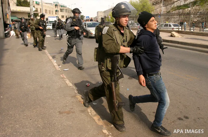Israeli border police officers detain Palestinian protesters during clashes on Land Day after Friday prayers outside Damascus Gate in Jerusalem's Old City March 30, 2012. Israeli security forces fired rubber bullets, tea...