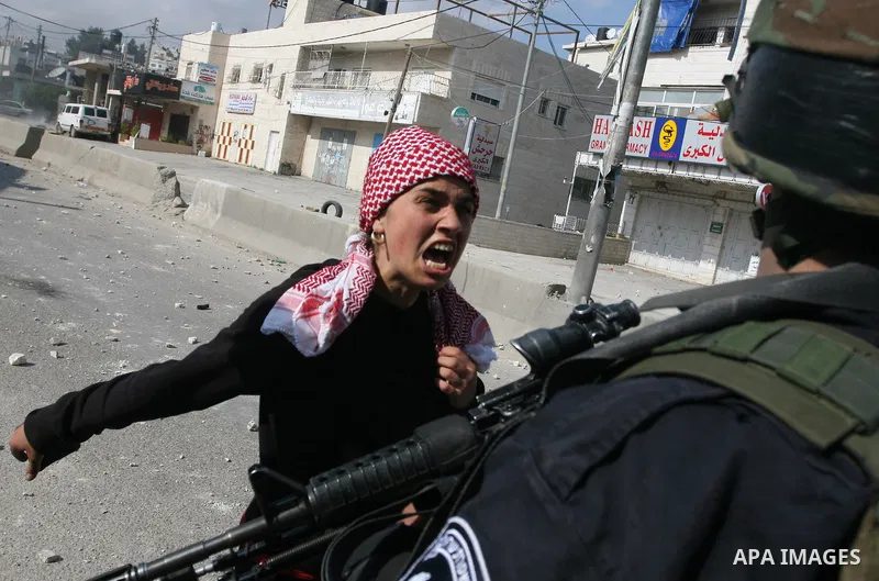 Foreign activists scuffle with Israeli security forces during clashes at a demonstration marking Land Day, at Qalandiya checkpoint, near the West Bank city of Ramallah March 30, 2012. Israeli security forces fired rubber...