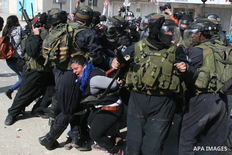 Foreign activists scuffle with Israeli security forces during clashes at a demonstration marking Land Day, at Qalandiya checkpoint, near the West Bank city of Ramallah March 30, 2012. Israeli security forces fired rubber...