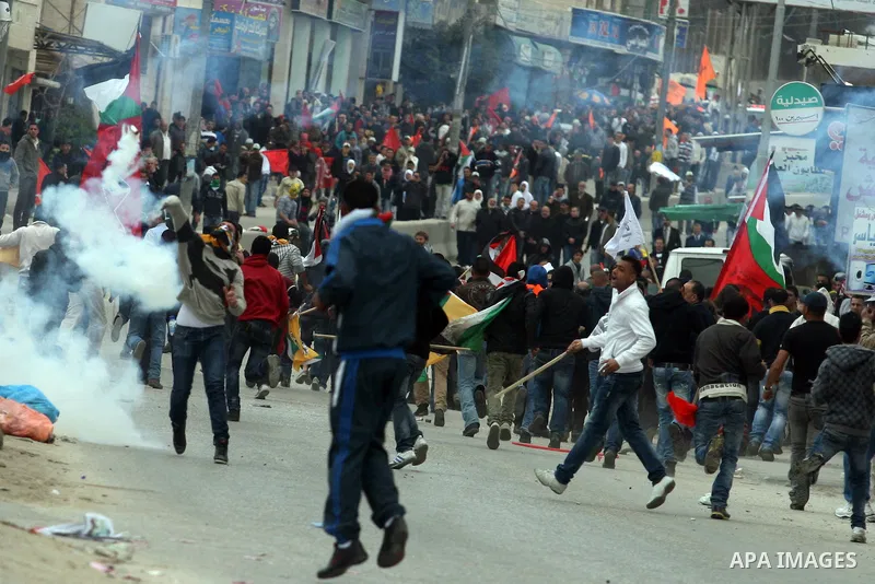 Palestinians protest as they mark the anniversary of Land Day in Qalandia which lies between Jerusalem and the West Bank city of Ramallah on March 30, 2012. Land Day marks the annual event that commemorates the deaths of...